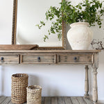 Three-drawer console table made from reclaimed, weathered pine