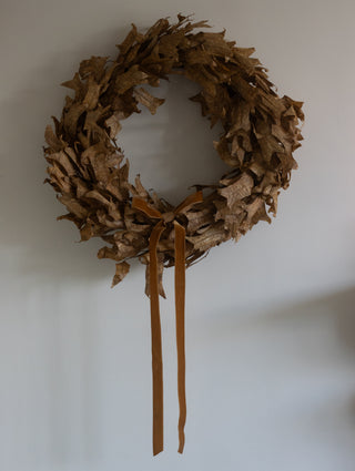 Close up of the natural dried leaves on the rustic brown autumn wreath
