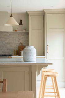 Crafted from terracotta, this vase features intricate ridged detailing and a distressed white glaze.