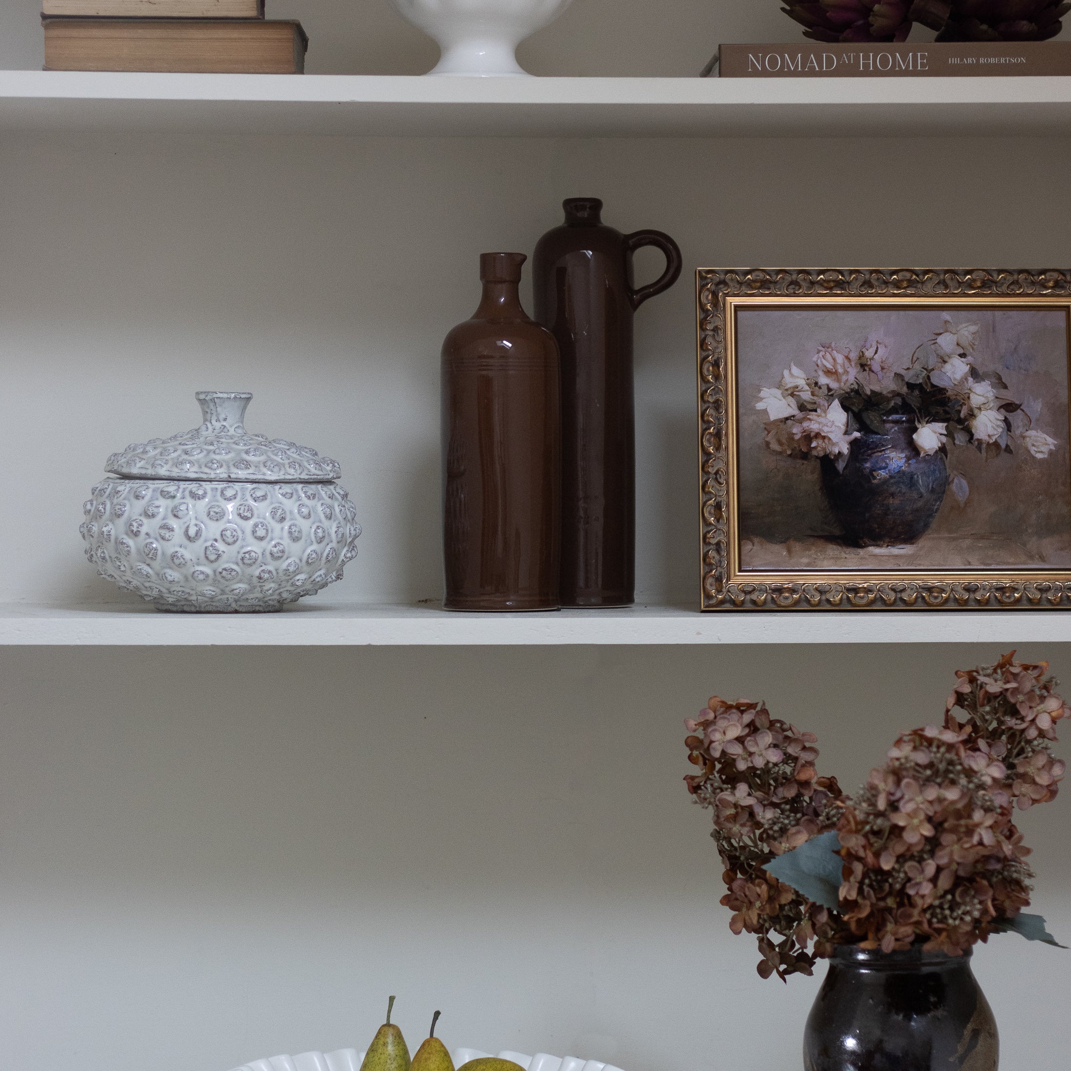 With a sleek, slender design, these exquisite ceramic jars exude a rich and opulent vintage brown hue.