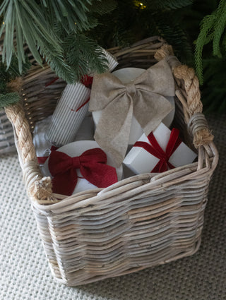 Red felt bow hanging on a Christmas tree branch
