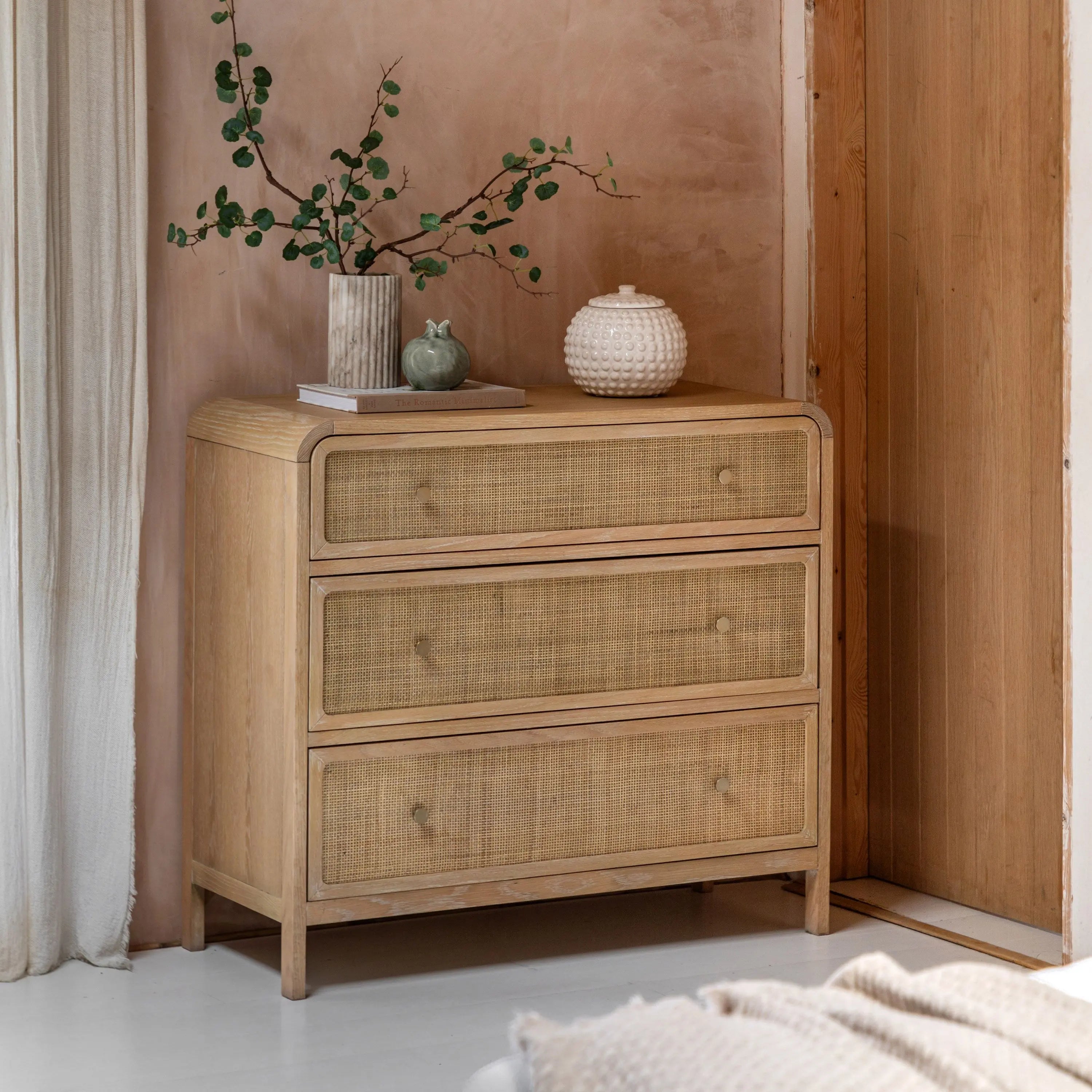 Cheltenham rattan chest of drawers in lime washed oak styled in bedroom
