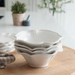 12-piece set of white ceramic scalloped dinner service.