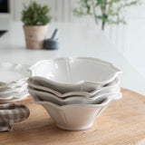 12-piece set of white ceramic scalloped dinner service.