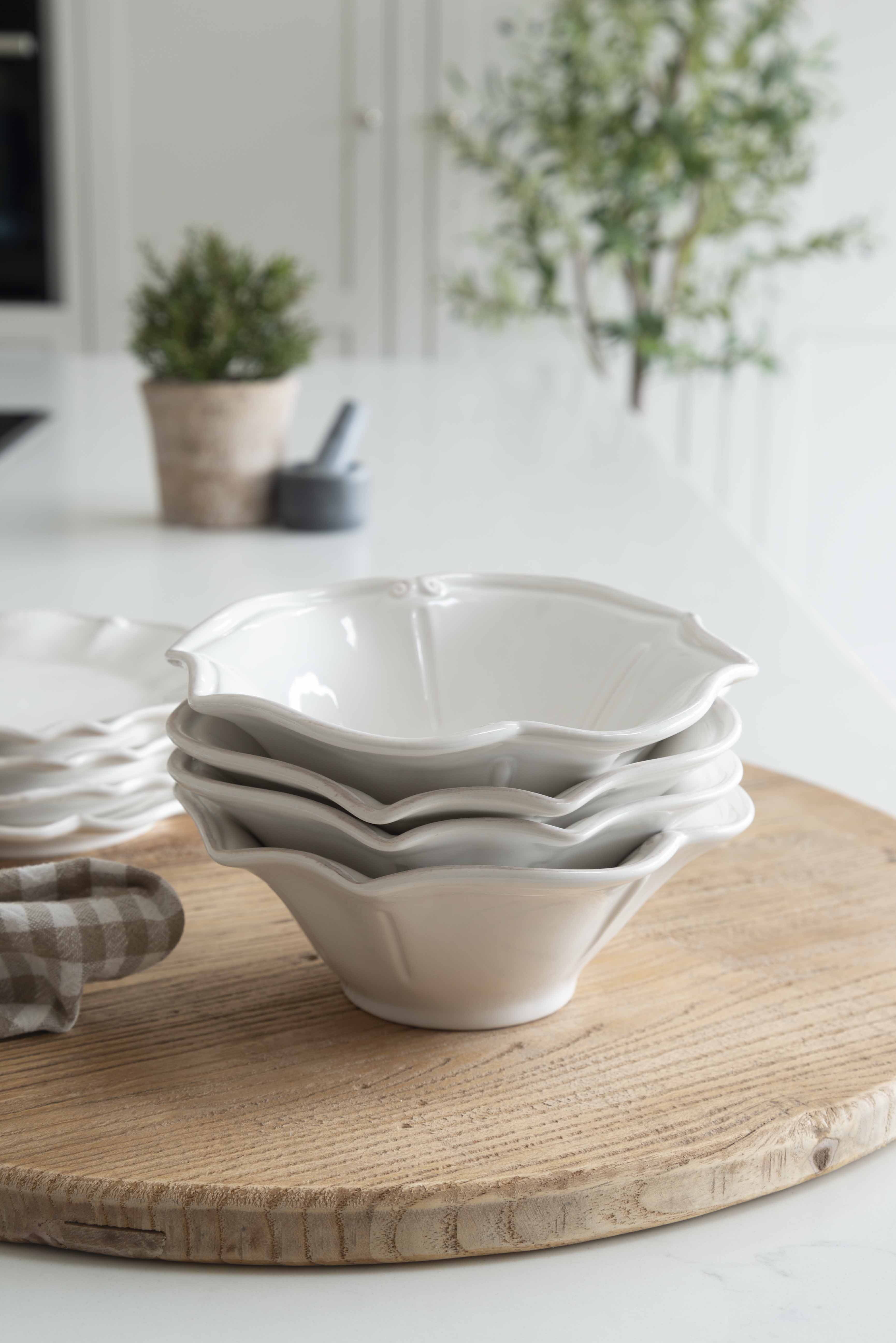 12-piece set of white ceramic scalloped dinner service.