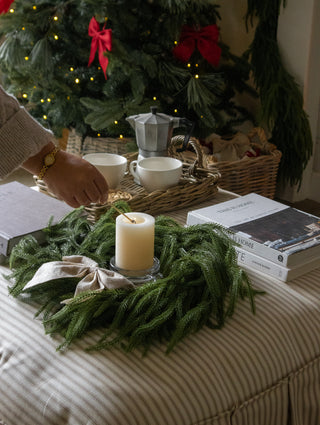 Linen felt bow on a table wreath centrepiece with candles