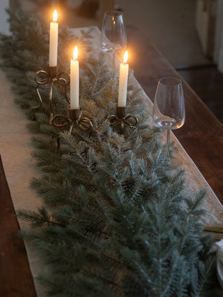 Noble pine garland as a Christmas table runner with tall taper candles
