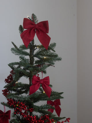 Red felt Christmas bows tied along a festive garland