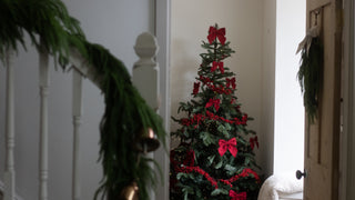 Traditional Christmas tree decorated with red felt bows