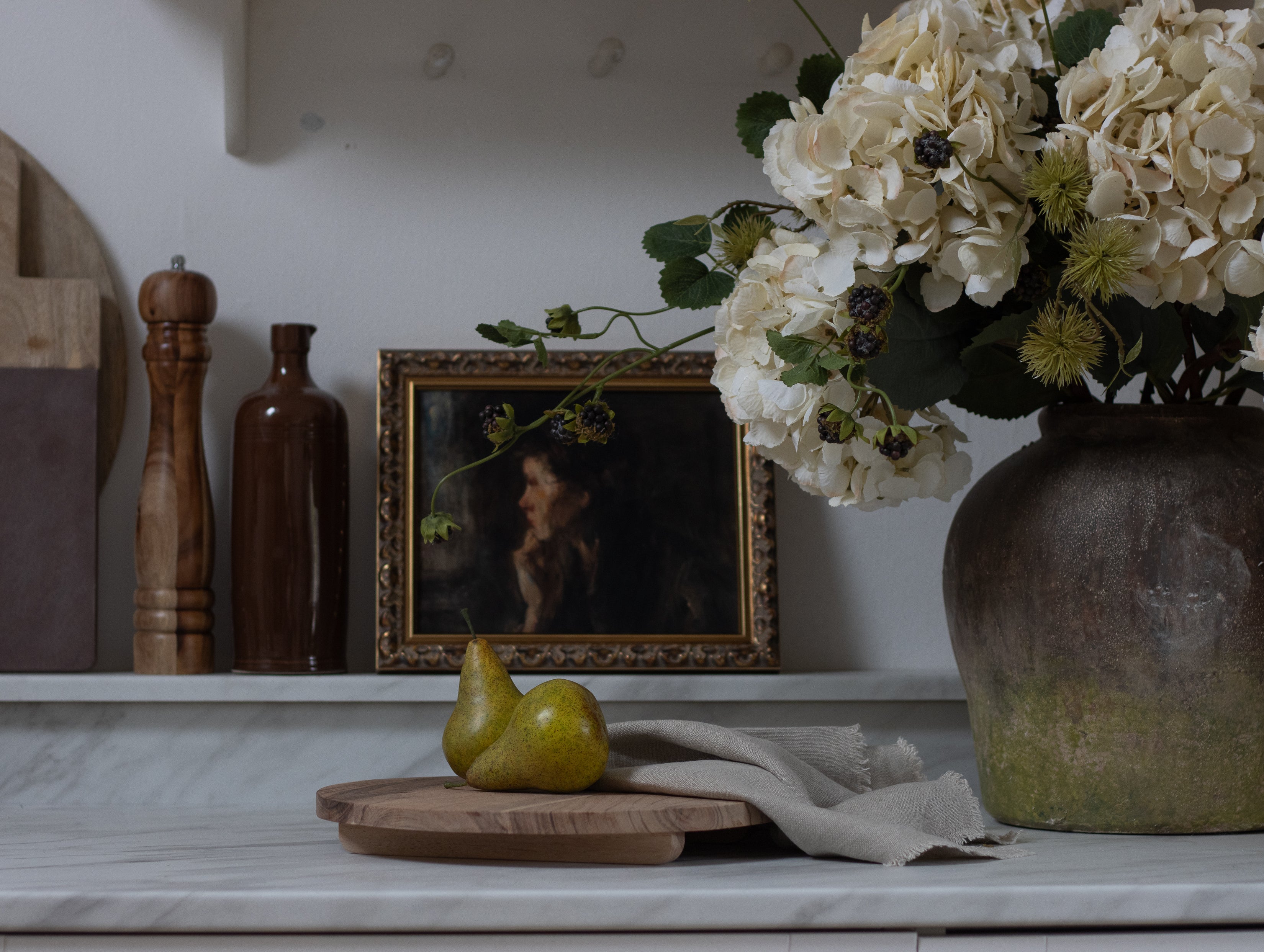 Two faux pairs, displayed on a breadboard next to a vase