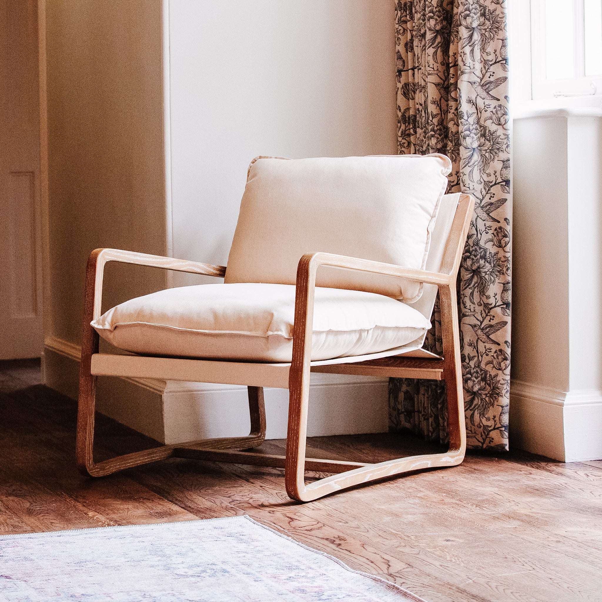 Shea Linen Armchair features a beautiful natural linen upholstery and an elegant ash wooden frame.