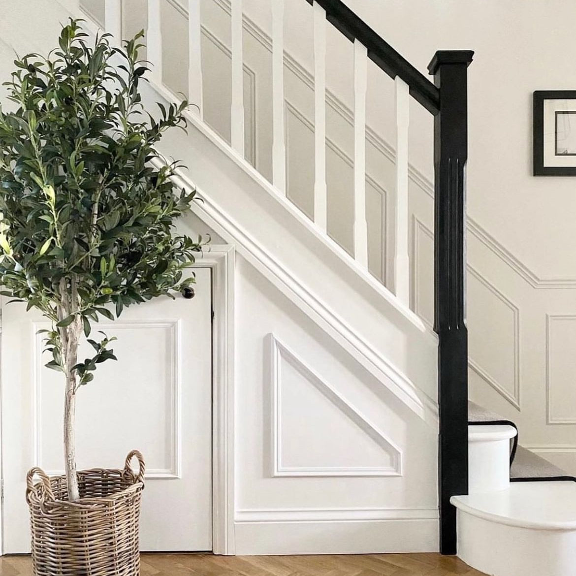 Large faux olive tree in a wicker basket