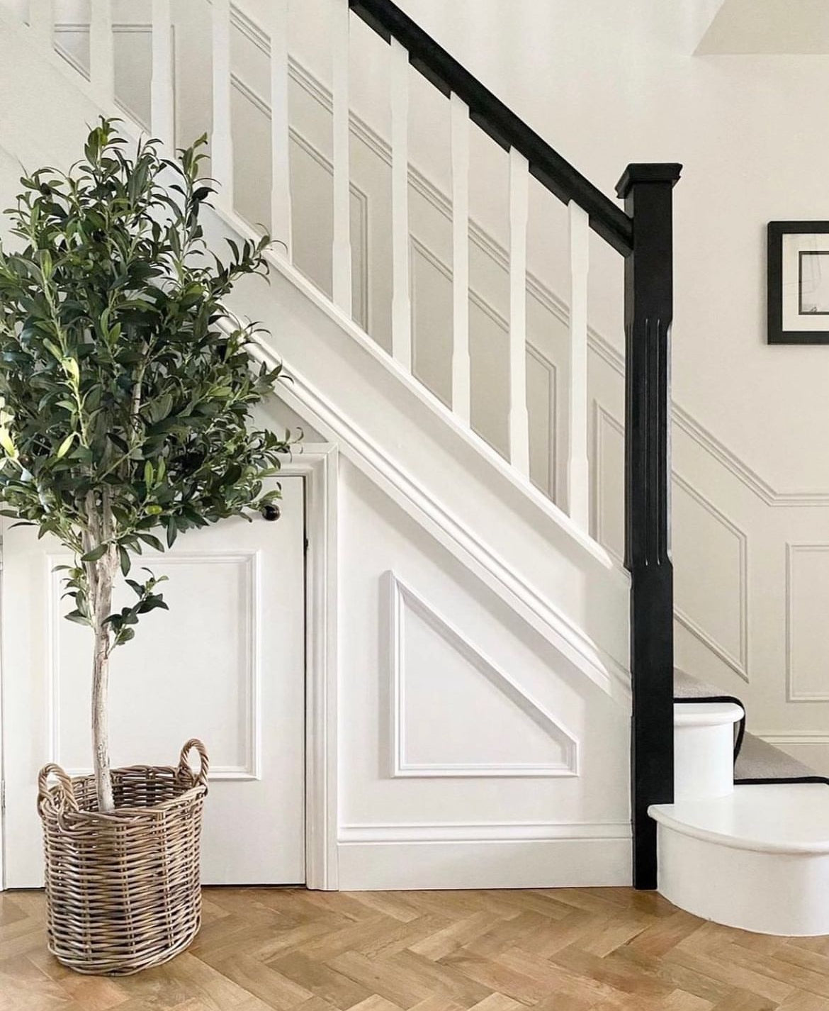 Large faux olive tree in a wicker basket