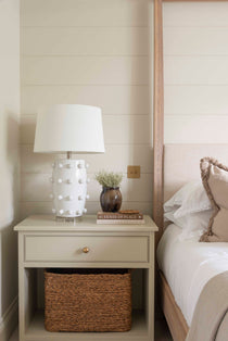  Crafted from sleek white ceramic and adorned with elegant bobble detailing, this lamp comes complete with a crisp white shade. 