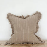A beautiful linen cushion in taupe with white stripe running through and ruffled edges
