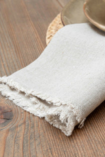 A beautiful natural linen napkin with delicate fringe detail.