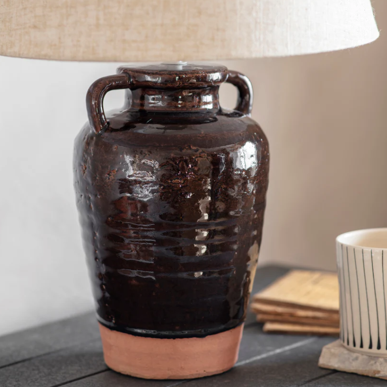 Close up of Charles Ted Adcote Rustic Brown Ceramic Table Lamp base with linen shade
