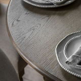 Antoine extendable dining table in limewashed oak, round shape with turned legs – farmhouse and coastal dining furniture - wood finish