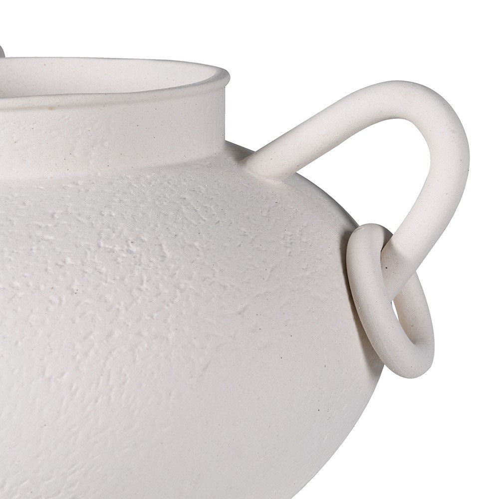 Close-up of matte white ceramic vase with textured finish and circular loop handle detail