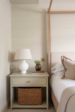 Aria White Ceramic Table Lamp styled on bedside table with books and decor