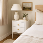 Two&nbsp;drawer white bedside table in solid oak and oak veneer, curved front, curved legs, cut lines, visible grain, metal runners on drawers and completed with a gold coloured square handle.


Dimensions:

H 60cm W 40cm D 45cm