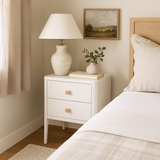 Two&nbsp;drawer white bedside table in solid oak and oak veneer, curved front, curved legs, cut lines, visible grain, metal runners on drawers and completed with a gold coloured square handle.


Dimensions:

H 60cm W 40cm D 45cm
