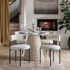Arya dining table styled in modern dining room with upholstered chairs