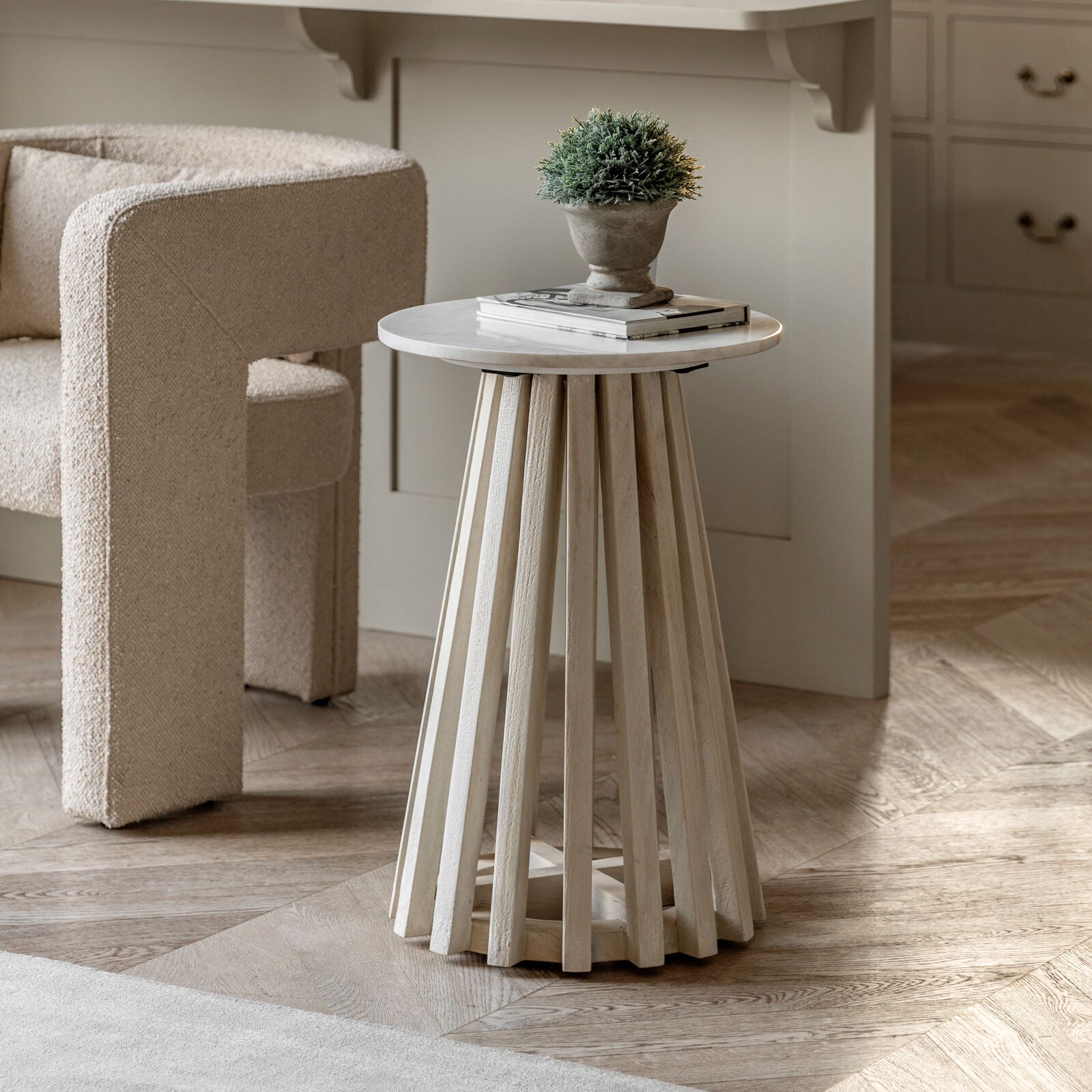 Arya side table styled in a cosy living room with modern armchair and decor books