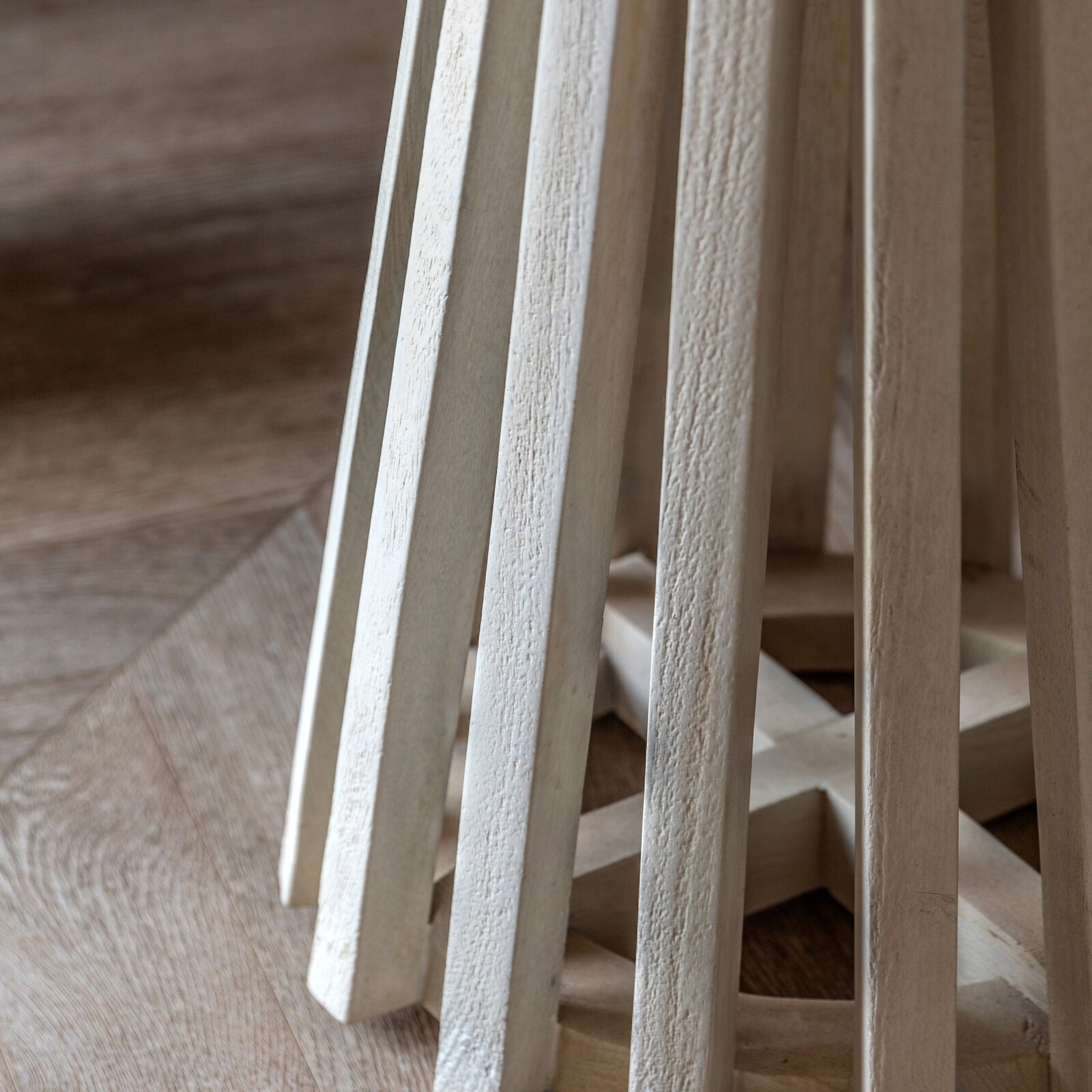 Close-up of the handcrafted pedestal base in light mango wood