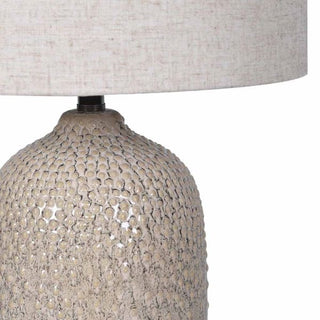Close-up of the Ashby lamp's dimpled, hand-pressed speckled stoneware base
