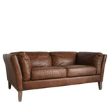 Side angle of the Ashford 2-seater vintage brown leather sofa with flared padded arms