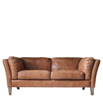 Front-facing view of mellow brown leather sofa on solid ash legs