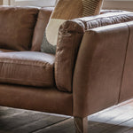 Close-up detail of soft vintage leather and cushioned armrest