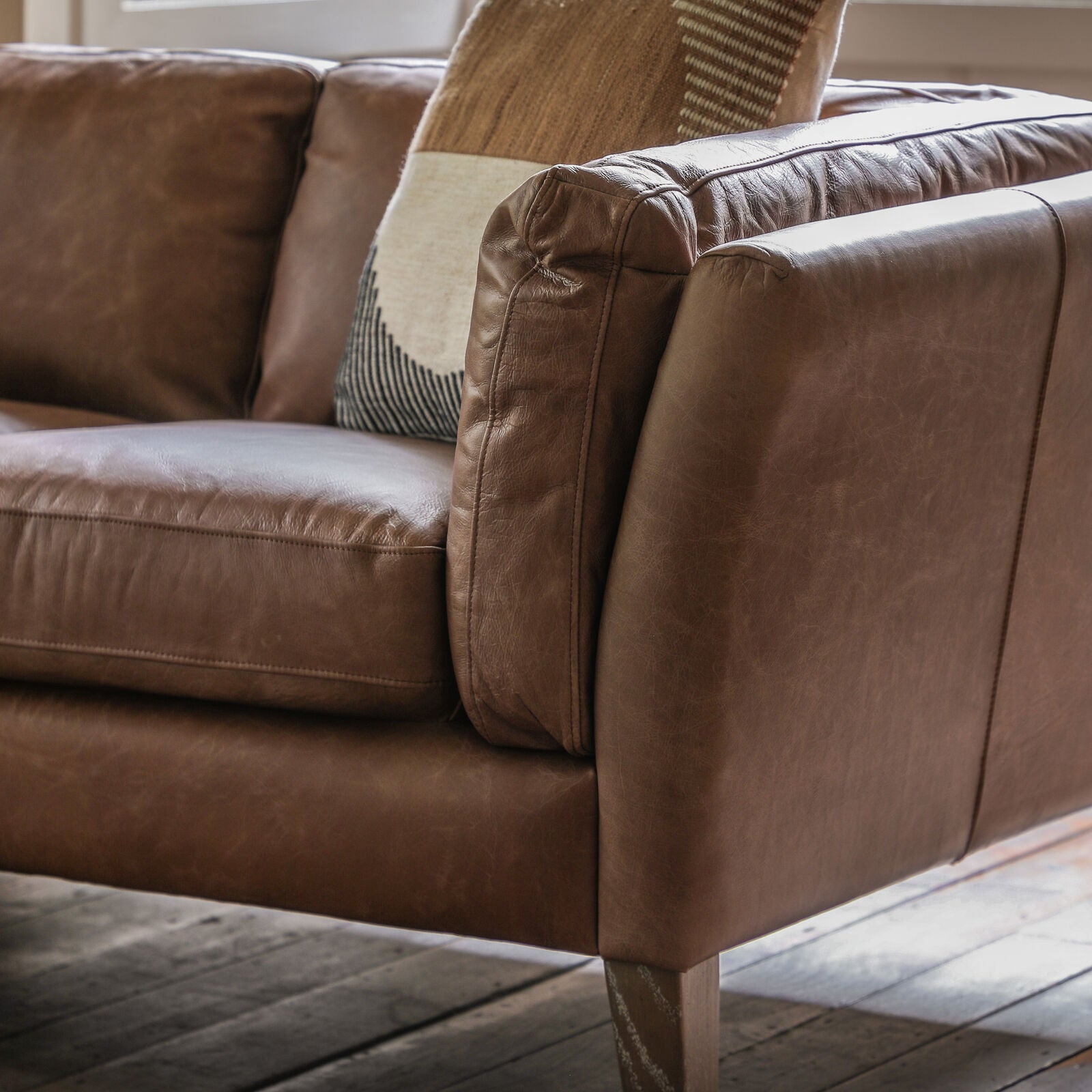 Close-up detail of soft vintage leather and cushioned armrest
