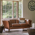 Ashford leather 2-seater sofa in styled living room by bay windows