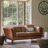 Ashford leather 2-seater sofa in styled living room by bay windows