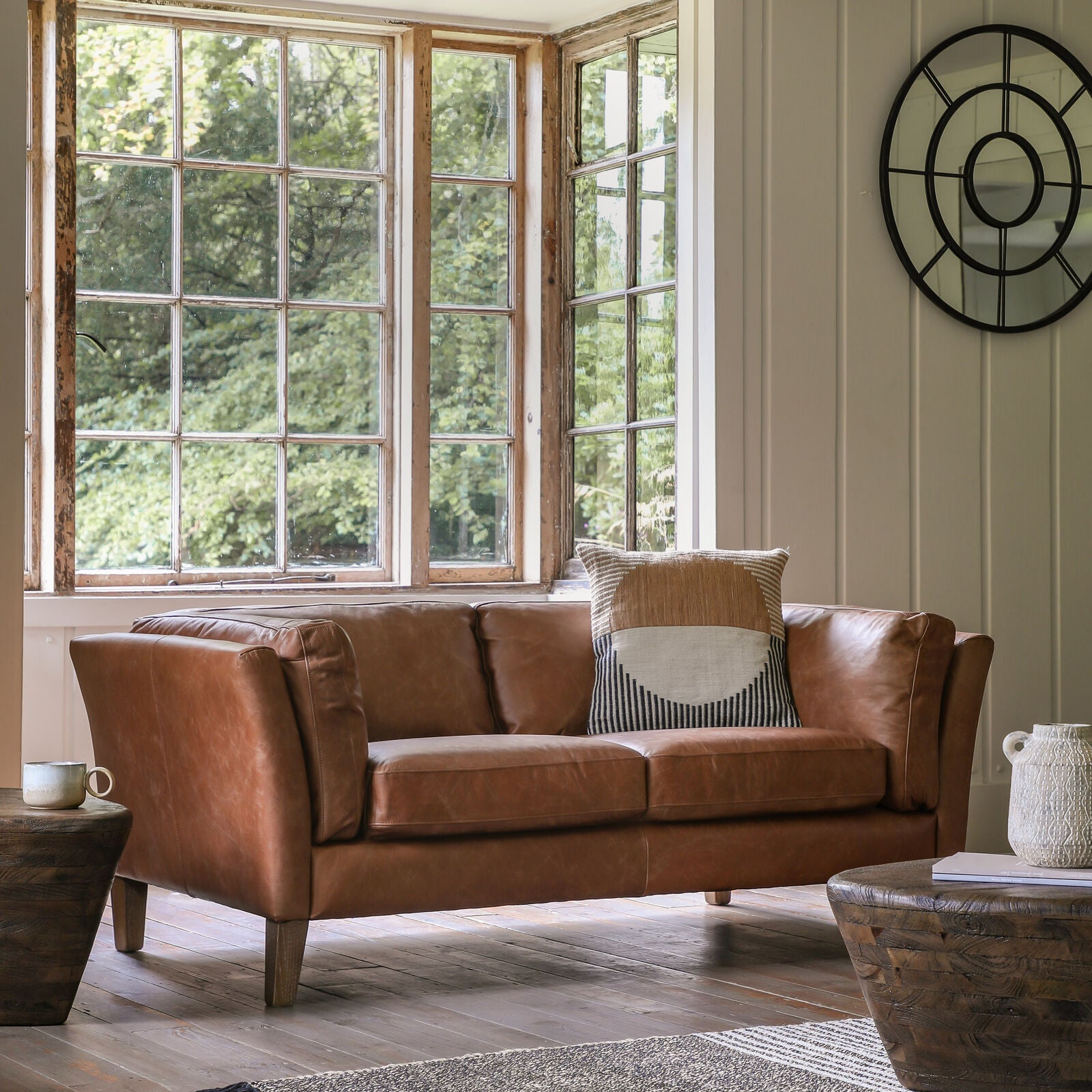Ashford leather 2-seater sofa in styled living room by bay windows