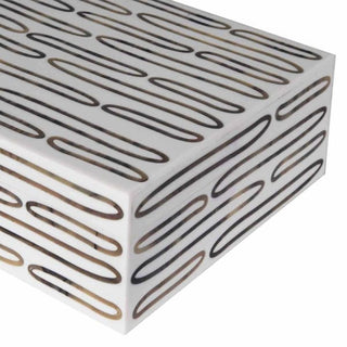 White box with black and gold geometric pattern on a white background