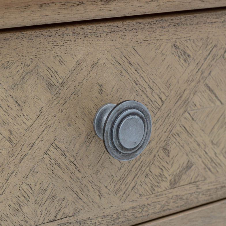 Close-up of a wooden drawer with a decorative knob