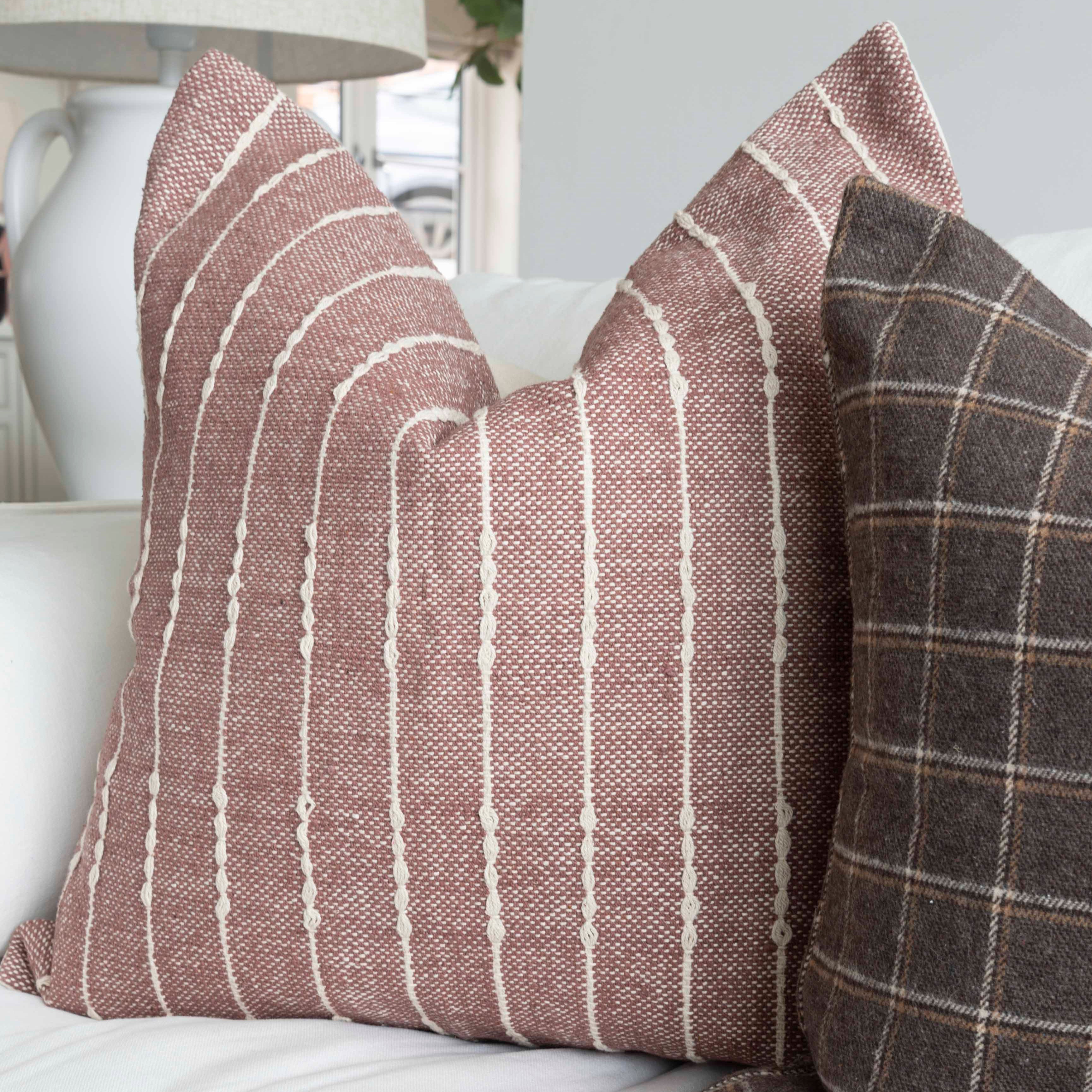 A stunning plum cotton cushion with a beautiful check Detail in cream.