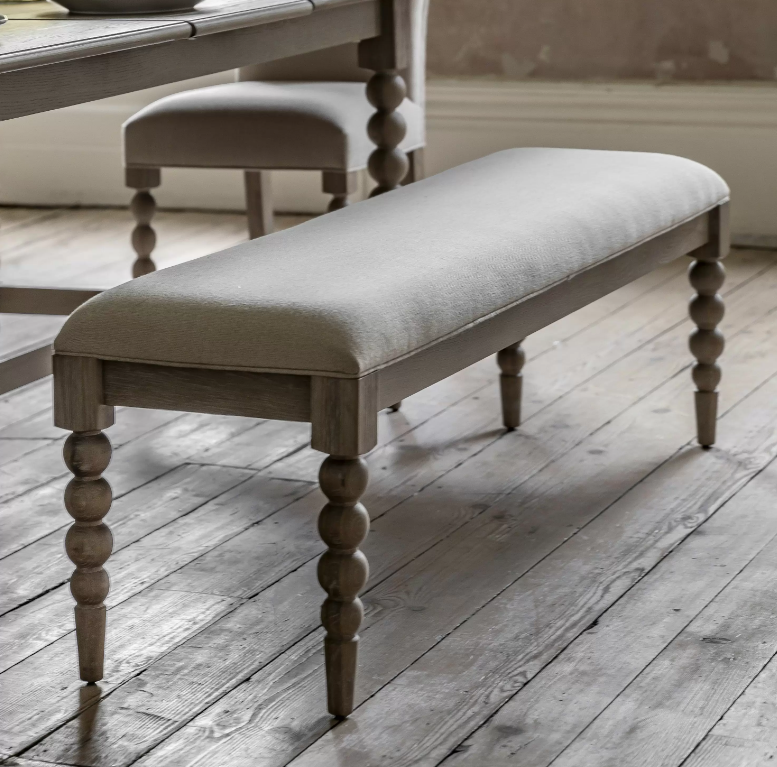 Beige upholstered bench with turned wooden legs
