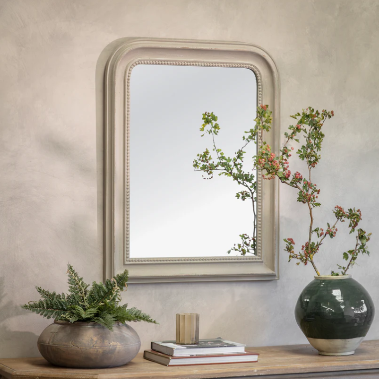 Rectangular wall mirror with rounded top and beaded frame in a distressed vintage finish