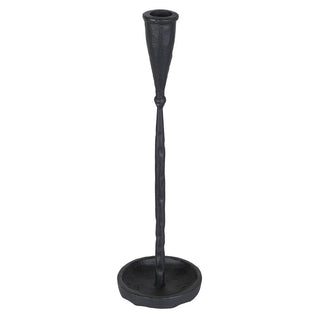 A black cast iron candlestick holder with a textured finish, featuring a tapered stem and a round base, shown against a plain white background.