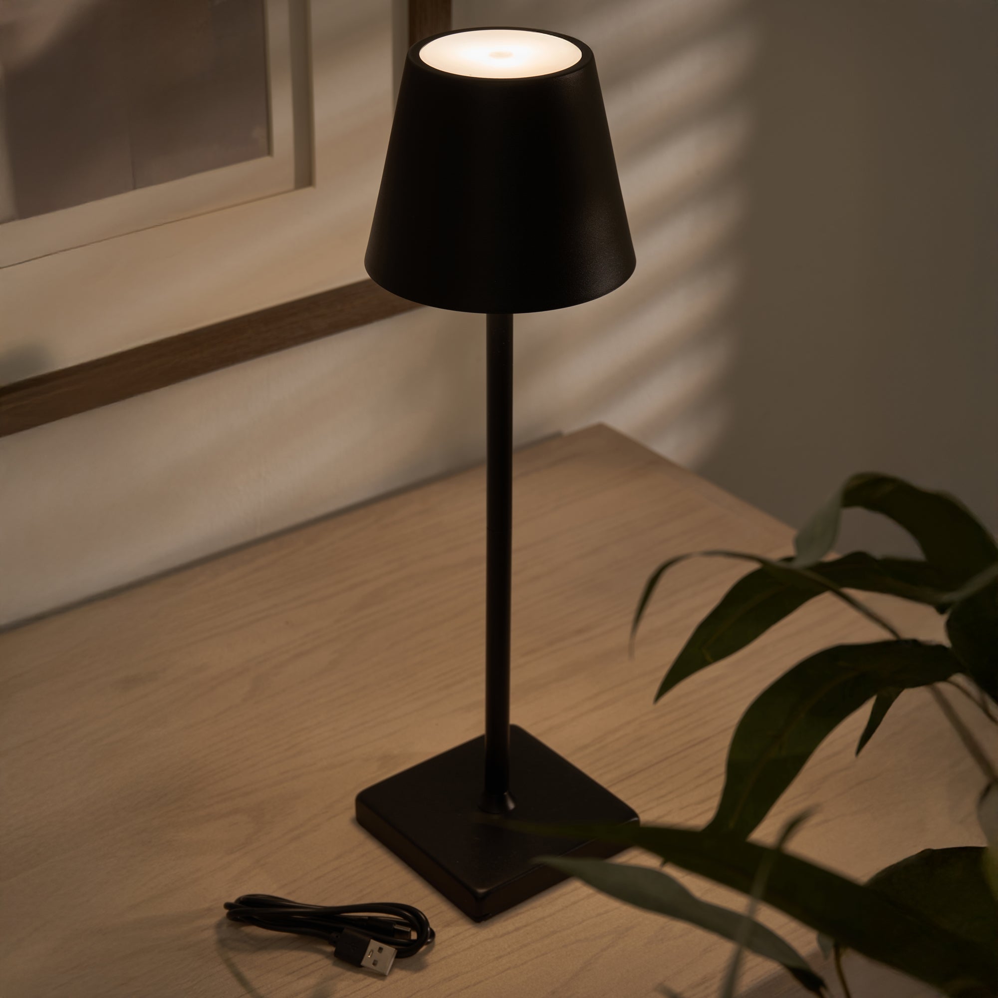 Sleek modern black wireless lamp with USB-C cable
