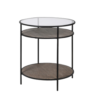 A round side table with a black metal frame and rattan detail, featuring a glass top and lower shelf.