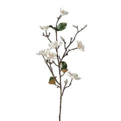 Artificial flower branch with white flowers and green leaves on a light gray background