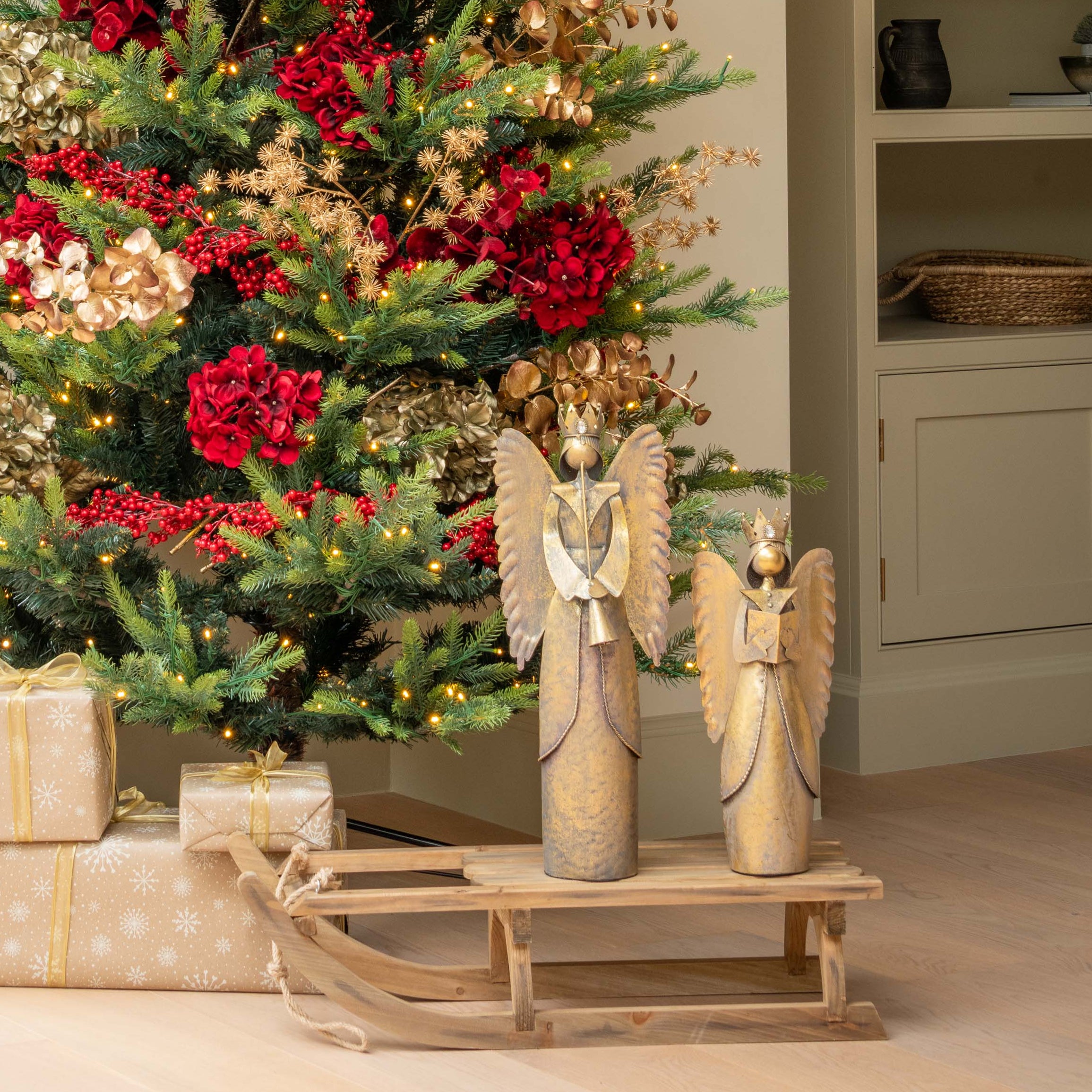 Decorated Christmas tree with red bows and ornaments in a living room.