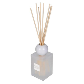 A reed diffuser with a frosted glass cube base, a white spherical top, and natural wood reeds, shown on a plain white background.