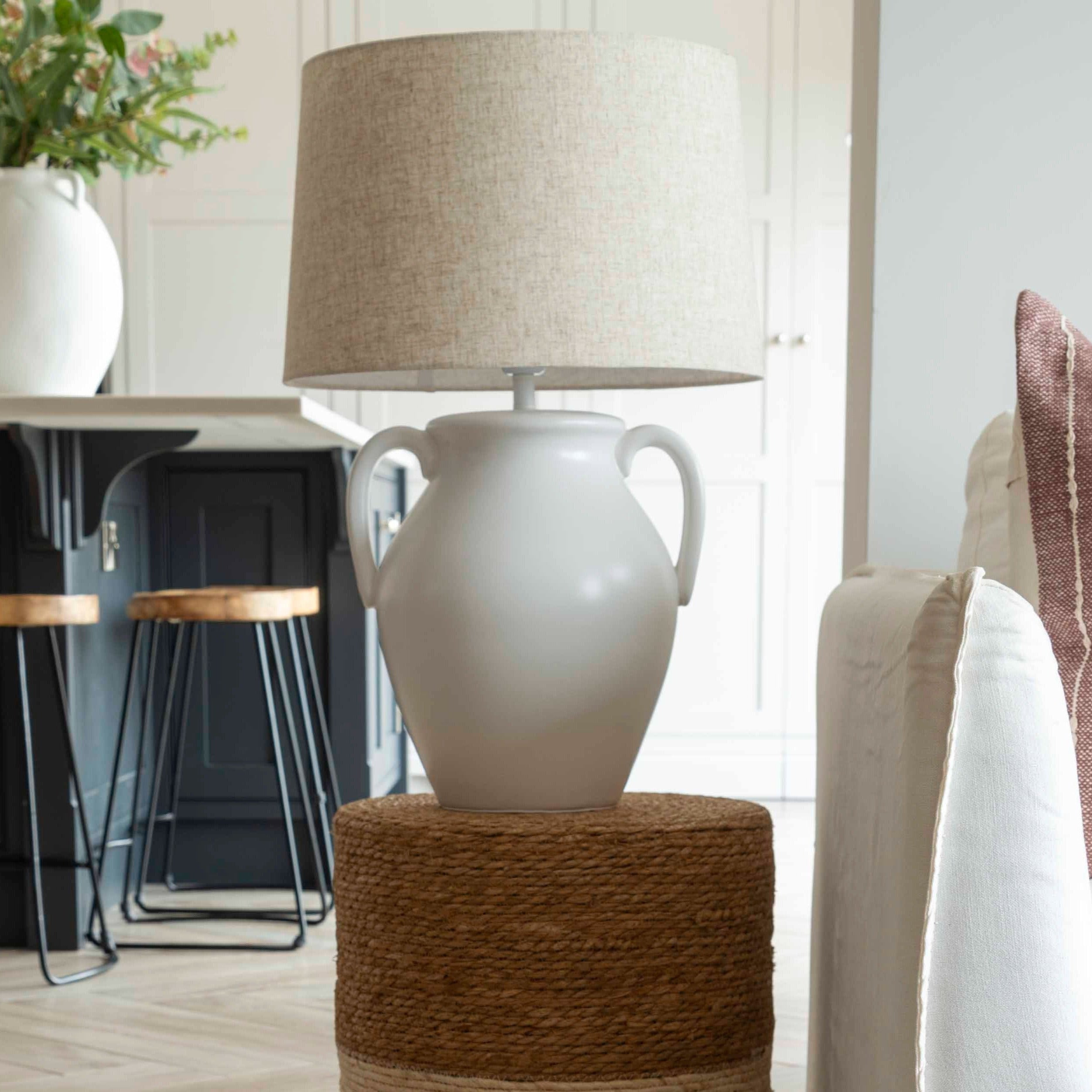 Modern urn-style ceramic lamp with linen shade in living room