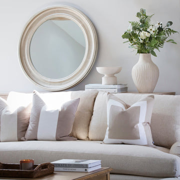 This gorgeous round mirror is complete with distressed silver detailing.